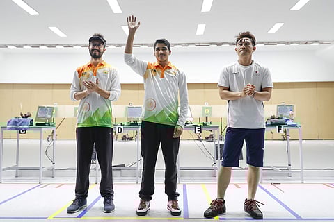 From left to right, bonze medalist India's Abhishek Verma, gold medalist India's Saurabh Chaudhary, and silver medalist Japan's Tomoyuki Matsuda poses for photographer after the 10m air pistol men's final shooting event during the 18th Asian Games in Pale