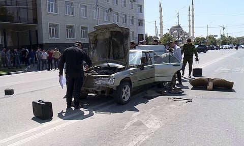 Investigators inspect a car that was allegedly used to attack police | AP