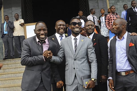 Ugandan pop star Kyagulanyi Ssentamu, better known as Bobi Wine, centre, leaves shortly after being sworn in as a member of parliament in Kampala, Uganda. (Photo | AP)