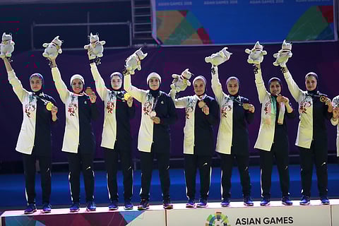 Iran's team members hold gold medals pose for photographers during the victory ceremony for the women's team Kabaddi event at the 18th Asian Games in Jakarta. (Photo | AP)