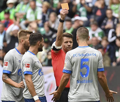 Referee Patrick Ittrich, second from right, shows the red card to Schalkes Matija Nastasic | AP