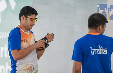 Indian shooter Anish Bhanwala(left) in action during Asian Games. (Photo | PTI)