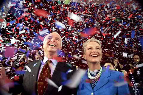 Confetti falls on Republican presidential hopeful Sen. John McCain, R-Ariz., and his wife, Cindy, at the end of their 114th New Hampshire town hall meeting with voters at the Peterborough Town House in Peterborough, N.H.  (Photo | AP)