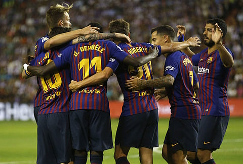 Barcelona's Ousmane Dembele celebrates with team mates scoring the opening goal during the Spanish La Liga match between FC Barcelona and Valladolid at the Nuevo Jose Zorrilla stadium in Valladolid. (Photo | AP)