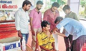 A doctor administering  tetanus vaccination to a volunteer