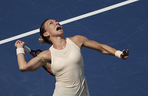 Simona Halep, of Romania, serves to Kaia Kanepi, of Estonia, during the first round of the U.S. Open tennis tournament. (Photo | AP)