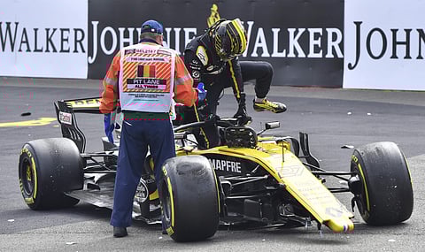 Renault driver Nico Hulkenberg of Germany, right, gets out of his car after crashing at the start of the Belgian Formula One Grand Prix in Spa-Francorchamps, Belgium, Sunday, Aug. 26, 2018. | AP