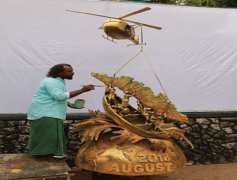 Da Vinci Suresh working on his 10-feet artwork which depicts fishermen and army personnel helping Kerala during the floods