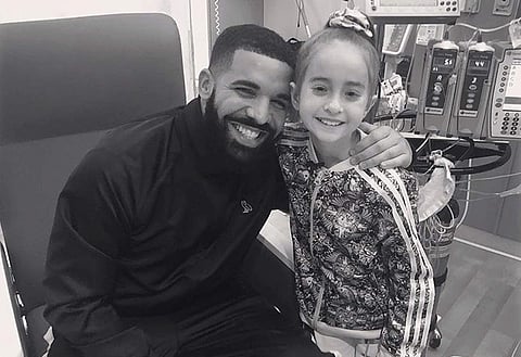 This Monday, Aug, 20, 2018 photo provided by the rapper Drake shows him posing with Sofia Sanchez, at Lurie Children's Hospital in Chicago. | AP