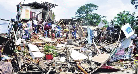Fire force personnel and local residents are engaged in rescue operations after a three-storey building collapsed in Palakkad on Thursday | Express