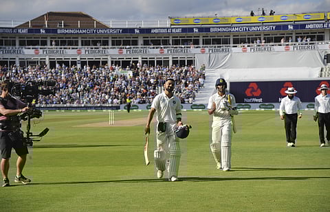 Indian cricket captain Virat Kohli leaves the field after being dismissed during the second day of the first test cricket match between England and India at Edgbaston in Birmingham, England, Thursday, Aug. 2, 2018. (AP Photo/Rui Vieira)