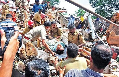A man rescued from the debris being shifted on a stretcher by the police and fire force personnel on Thursday | Express