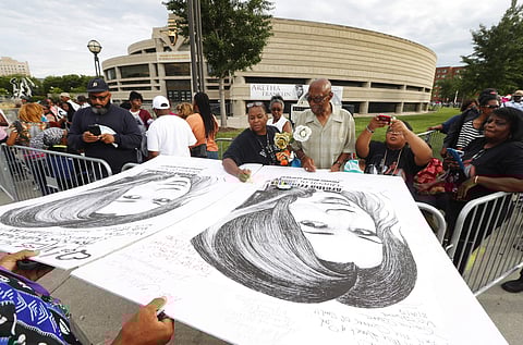 Mourners streamed in for a second day Wednesday to pay their respects to Aretha Franklin, who was dressed in a different outfit for her final public viewing, as if making a costume change during a show. In image: People in line sign well wishes on poster boards outside the Charles H. Wright Museum of African American History during a public visitation for Aretha Franklin in Detroit, Wednesday, Aug. 29, 2018. | AP