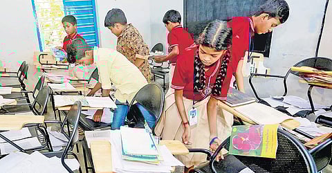 Students of West UP School, Cheranalloor, gathering their books in classroom after returning to school | Express