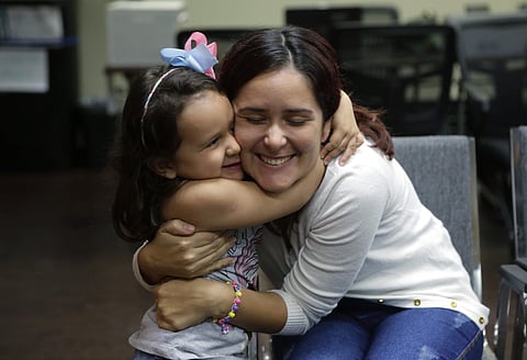 Immigrants seeking asylum Natalia Oliveira da Silva and her daughter, Sara, 5, hug as they wait at a Catholic Charities facility, Monday, July 23, 2018, in San Antonio. Since their separation in late May, the girl had been at a shelter for immigrant minor