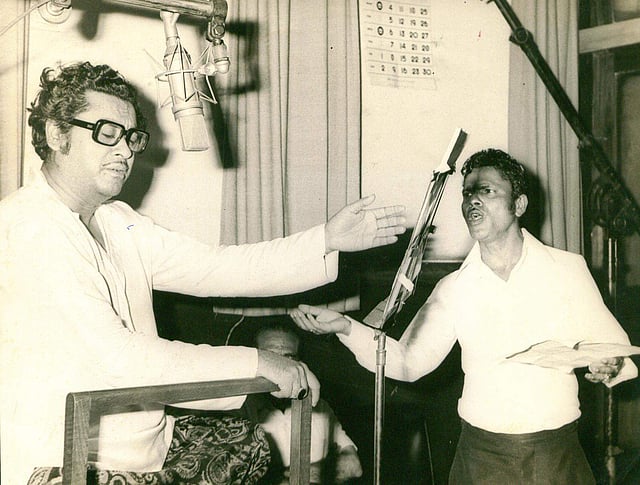 Abhas Kumar changed his name to 'Kishore Kumar' and started his cinema career as a chorus singer at Bombay Talkies. Music director S. D. Burman is credited with spotting Kumar's talent for singing. (During a song recording - Express photo)