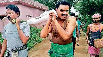 Rengali MLA Ramesh Patua (left) carrying the body of Ghudken. | Express Photo Services