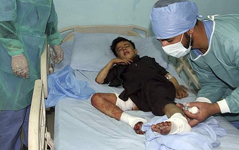 Doctors assist a wounded young man in a hospital after a deadly attack on a Shiite mosque in Gardez, the capital of Paktia, Afghanistan, Friday, Aug. 3, 2018. | AP