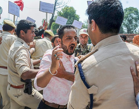 Police personnel clash with National Conference supporters who were raising slogans during a protest march against the petitions filed in the Supreme Court challenging the validity of Article 35 A in Srinagar on August 4 2018. (Photo | PTI)