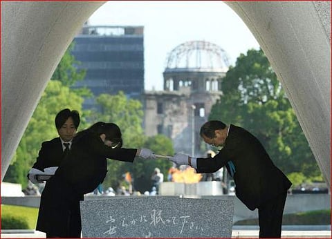 Hiroshima Mayor Kazumi Matsui, right, dedicates the list of the victims of atomic bombing to the cenotaph during a ceremony to mark the 73rd anniversary of the bombing at Hiroshima Peace Memorial Park in Hiroshima. (Photo | AP)
