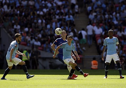 Manchester City's Phil Foden, center front, battles for the ball with Chelsea's Ross Barkley during the Community Shield soccer match between Chelsea and Manchester City at Wembley, London, Sunday, Aug. 5, 2018. | AP