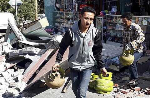 Indonesia evacuated hundreds of tourists from popular resorts and sent rescuers fanning across the holiday island of Lombok after a powerful quake killed at least 91 people and reduced thousands of buildings to rubble. | AP