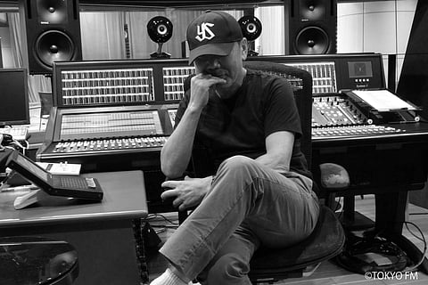 In this undated black and white photo provided by Tokyo FM Broadcasting Co., Japanese novelist Haruki Murakami poses at its radio station in Tokyo. | AP