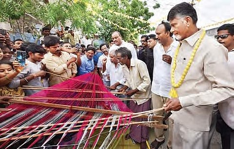 CM N Chandrababu Naidu takes a look at the weaving of a saree during his visit to Pandillapalli village in Prakasam district on Tuesday I Express