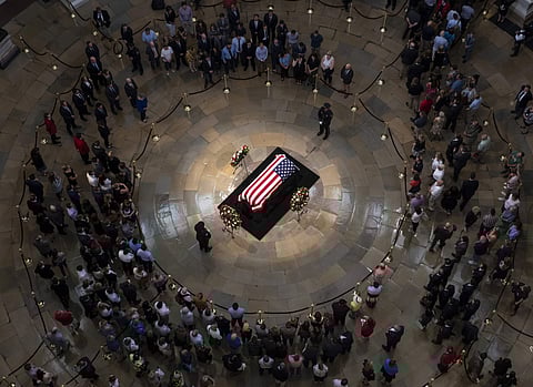 Members of the public walk past the flag-draped casket bearing the remains of John McCain of Arizona, who lived and worked in Congress over four decades, in the U.S. Capitol rotunda in Washington (Photo | AP)