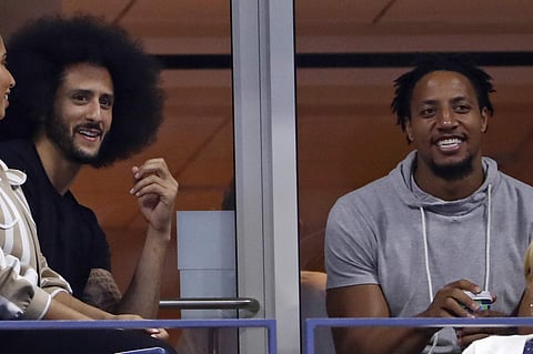 Colin Kaepernick (L) and Eric Reid look watch Serena Williams play Venus Williams during the third round of the US Open tennis tournament Friday | AP