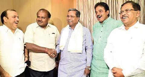 Siddaramaiah greets H D Kumaraswamy during the meet at KK Guest House on Friday. Danish Ali, K C Venugopal and G Parameshwara look on | Nagaraja Gadekal