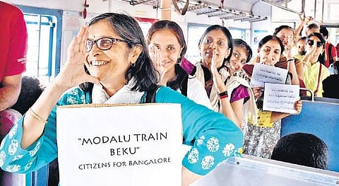 Citizens hop on the suburban train demanding an efficient public transport system in Bengaluru, on Friday  | Pushkar V