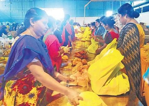 Workers at the Kudumbashree’s relief kit collection and distribution centre in Kalamassery