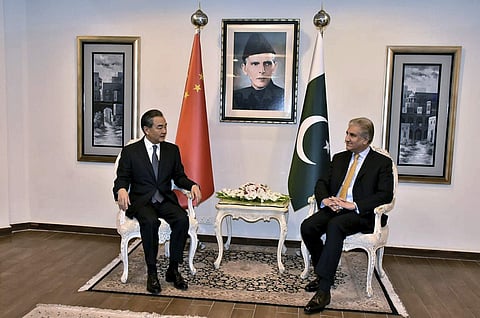In this picture released by Press Information Department, visiting Chinese foreign minister Wang Yi, left, meets with his Pakistani counterpart Shah Mahmood Qureshi, in Islamabad. (File Photo | AP)