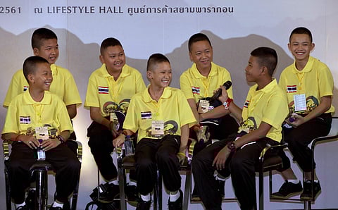 Members of the Wild Boars soccer team laugh during a public discussion in Bangkok, Thailand, Thursday, Sept. 6, 2018. They spoke Thursday at an exhibition about their ordeal of being trapped for almost three weeks in a flooded cave, at one of Bangkok's la