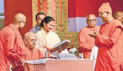 Mamata Banerjee with Ramakrishna Math head Swami Smaranananda and other monks at the launch of a book to commemorate the 125th anniversary of Swami Vivekananda’s speech at Parliament of World’s Religions in Chicago. | PTI