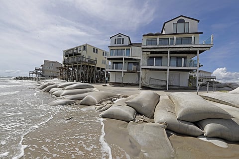 Sand bags surround homes on North Topsail Beach, N.C., Wednesday, Sept. 12, 2018, as Hurricane Florence threatens the coast. (Photo | AP)