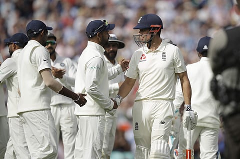 England's Alastair Cook, in his last ever batting innings before retiring from test cricket, shakes hands with India's Shikhar Dhawan. | AP