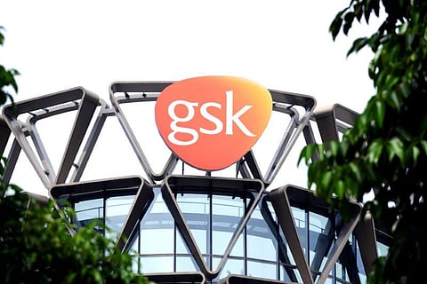 The GlaxoSmithKline (GSK) logo is seen on top of GSK Asia House in Singapore. (Photo | Reuters)