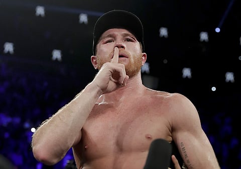 Canelo Alvarez reacts after defeating Gennady Golovkin by majority decision in a middleweight title boxing match. | AP