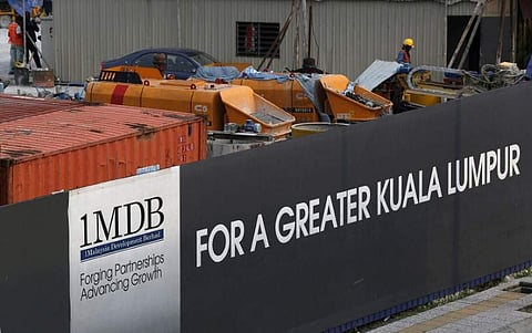 Workmen are pictured on site at the 1 Malaysia Development Berhad (1MDB) flagship Tun Razak Exchange development in Kuala Lumpur, Malaysia. (Photo | Reuters)