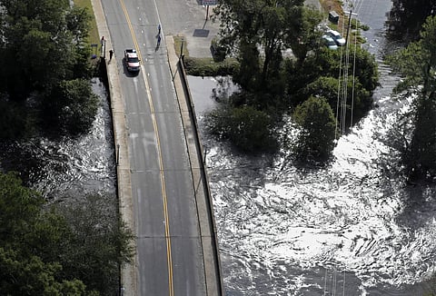 Water rushes just underneath a bridge in Lumberton, N.C., in the aftermath of Hurricane Florence | AP