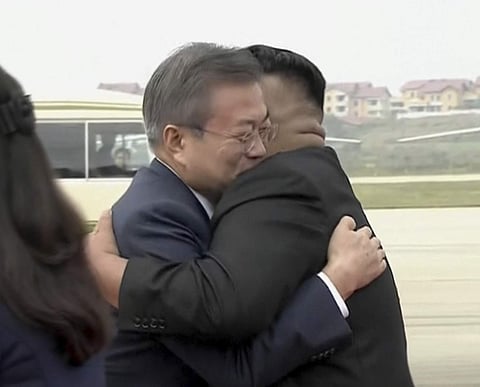 In this image made from video provided by Korea Broadcasting System (KBS), South Korean President Moon Jae-in, left, hugs North Korean leader Kim Jong Un upon arrival in Pyongyang, North Korea, Tuesday, Sept. 18, 2018. (Photo | AP)