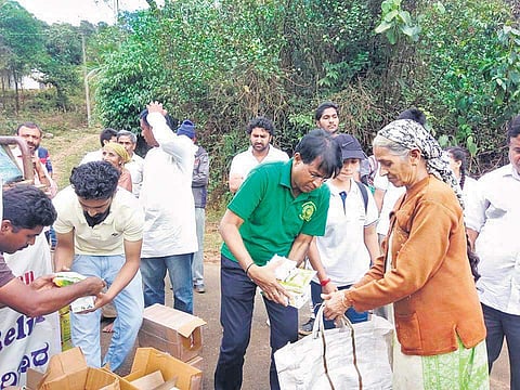Dr Ashok D Hanjagi, along with his team of students, hand out relief material to the victims of the flooding in Kodagu