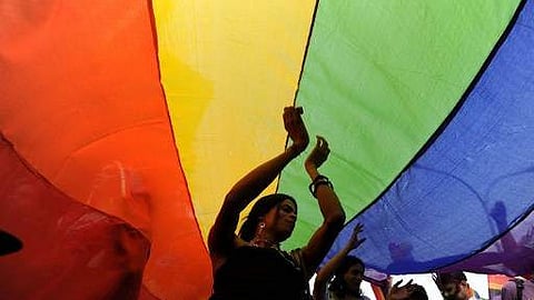 Image of LGBQA+ community members with a pride flag used for representational purposes only