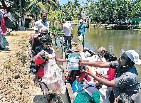 Students of Government Vocational Higher Secondary School, East Maradi, distributing flood relief kits at Ward-2 of Pulinkunnu panchayat in Kuttanad