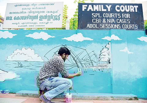 A student of a private institution beautifying the wall of the Family Court in Kaloor by painting Chinese nets on Gandhi Jayanti day | Albin Mathew