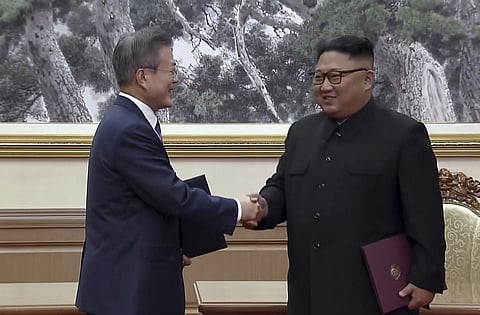 In this image made from video provided by Korea Broadcasting System (KBS), South Korean President Moon Jae-in, left, and North Korean leader Kim Jong Un shake hands after signing documents in Pyongyang. (Photo | AP)