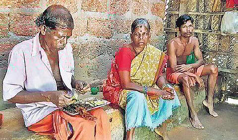 Mankukutty T, wife Sundari and son Suresh T in their shack at Thottathumoola colony in Bellur.