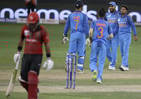 India's Kuldeep Yadav, right, celebrates with teammates the dismissal of Hong Kong's captain Anshuman Rath, left, during the Asia Cup match between India and Hong Kong in Dubai, United Arab Emirates, Tuesday, Sept. 18, 2018.| AP